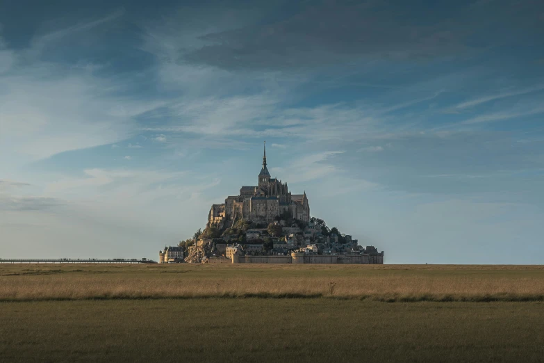 a big building that has some sky and clouds