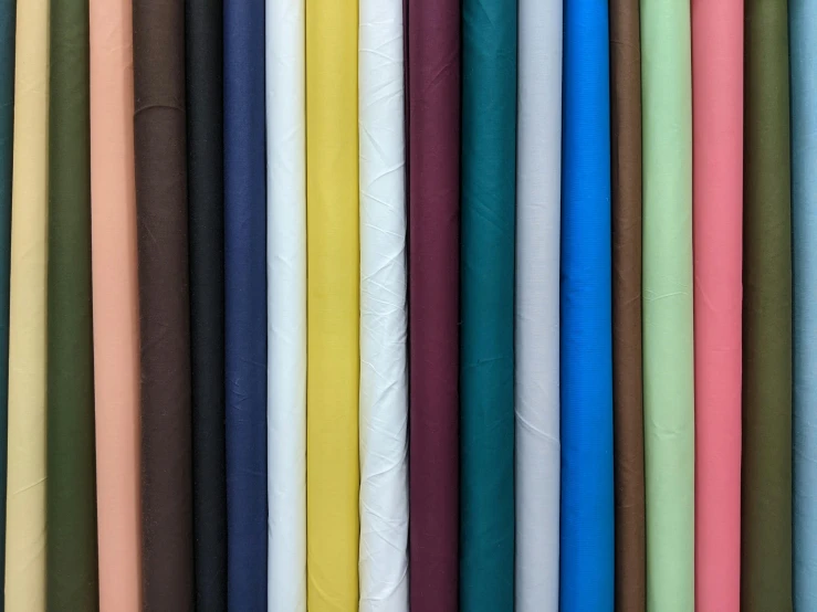 a wall of multicolored paper are lined up