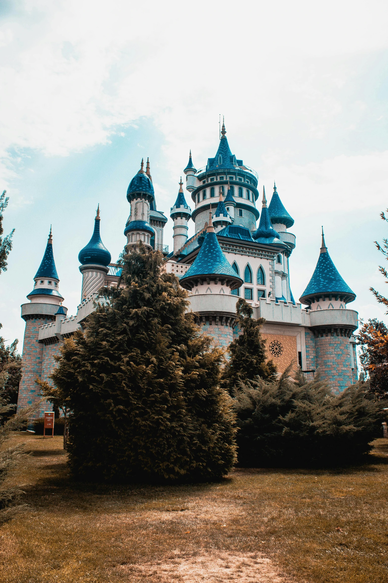 the building in the park has lots of towers on it