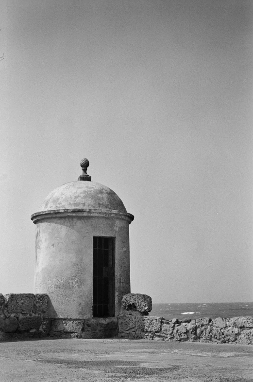 an old round structure with a door on the side