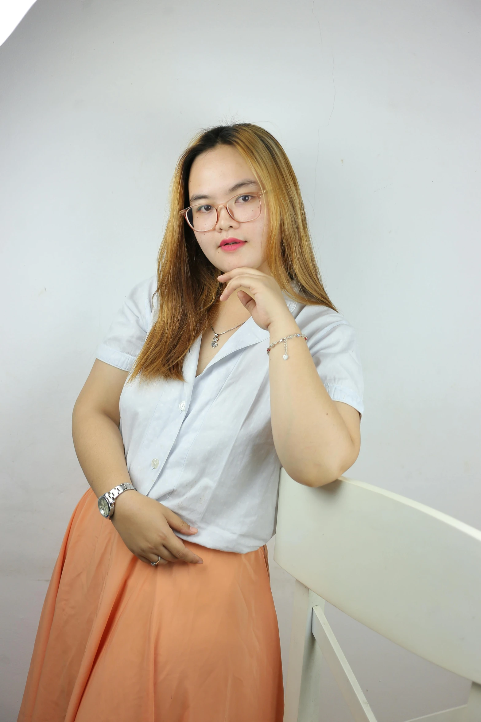 a woman posing for a po on a white wall