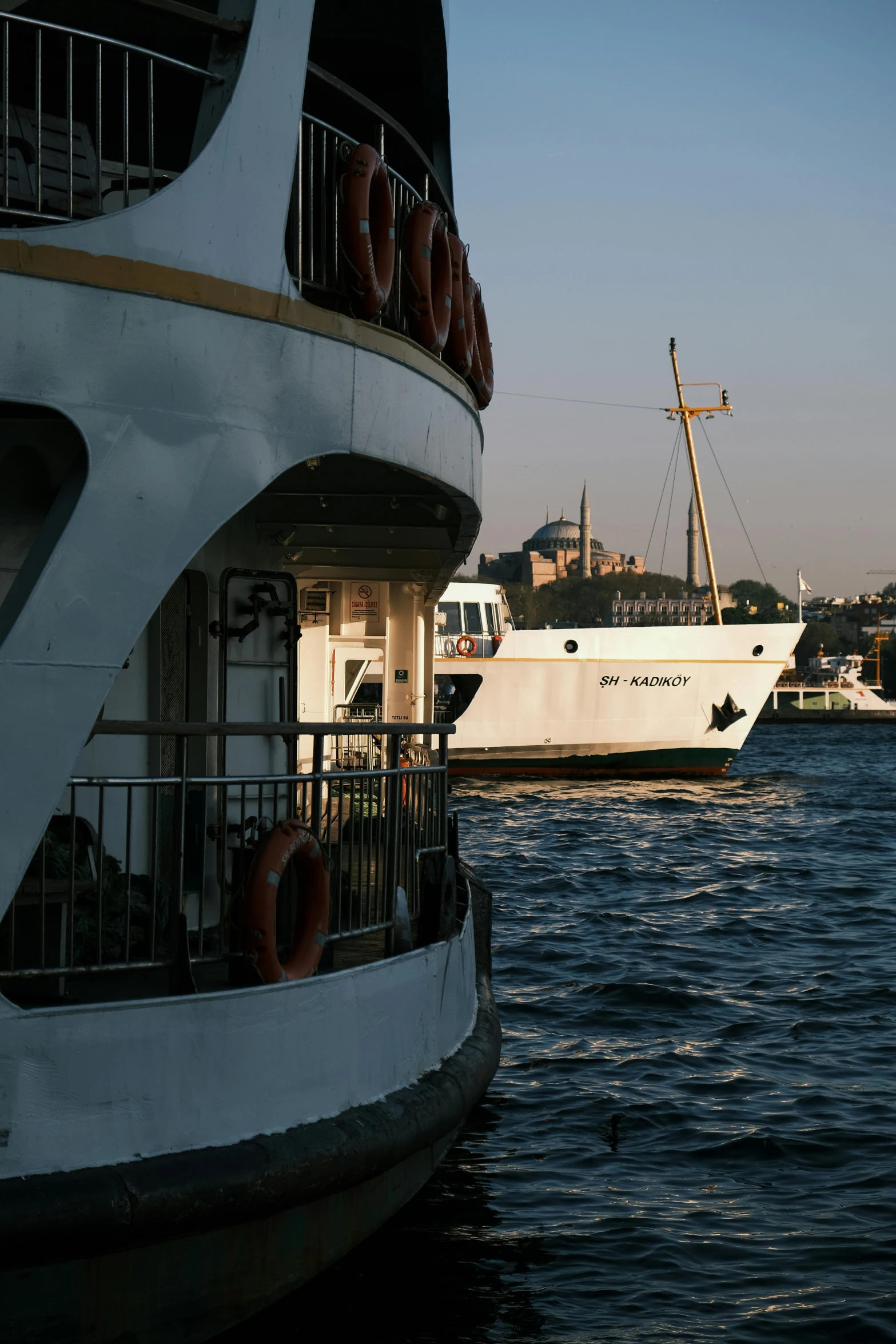 a boat in the water with two dock levels, next to other boats