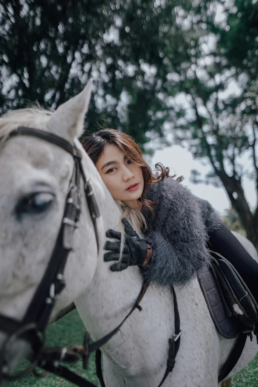 the young woman is posing on her horse