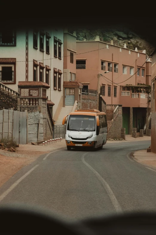 the vehicle is driving down the narrow road