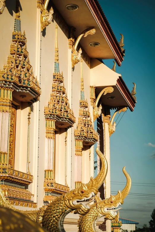 golden sculptures stand outside an intricately decorated building