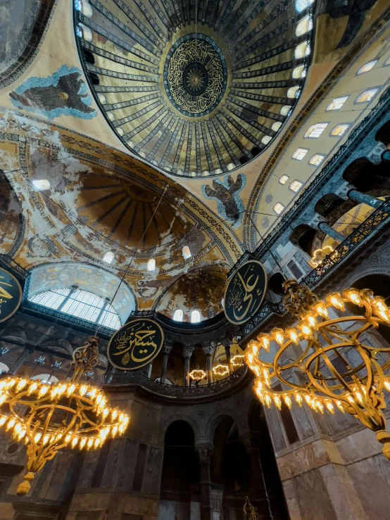 large ornate building with chandeliers on the ceiling and a clock hanging