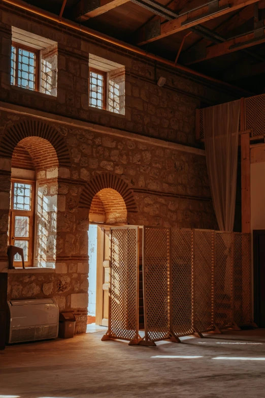 open glass doors in the middle of a stone walled building