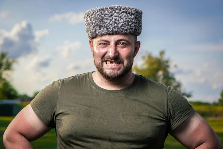 a man poses with a hat on his head