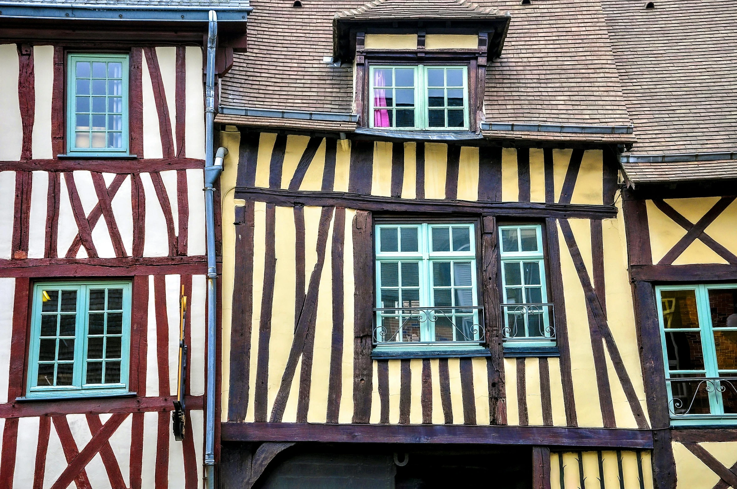 a couple of wooden and white building sitting next to each other