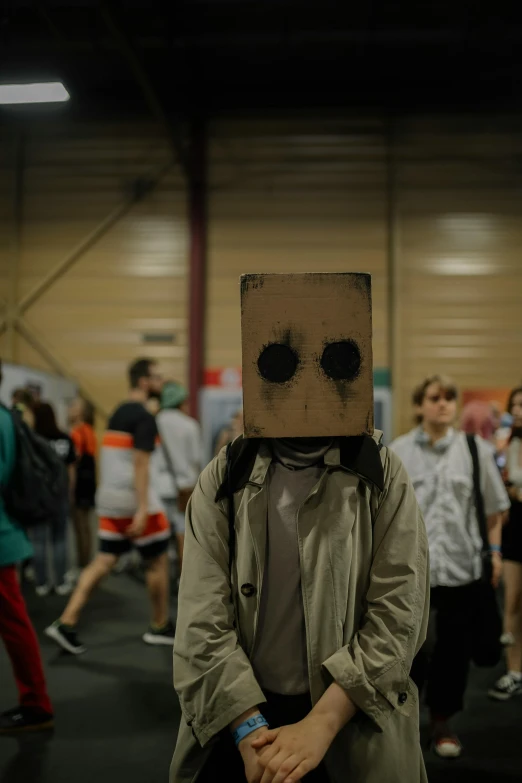 a man in a suit and tie is wearing a box like costume