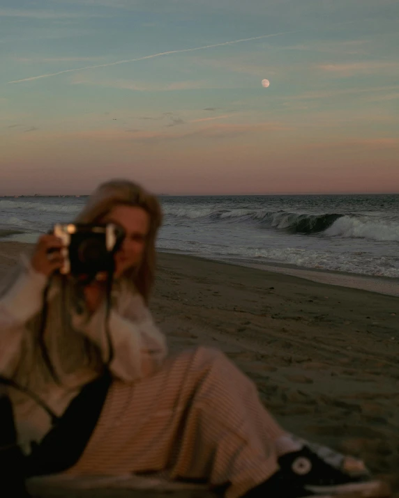 the woman is on the beach taking a po