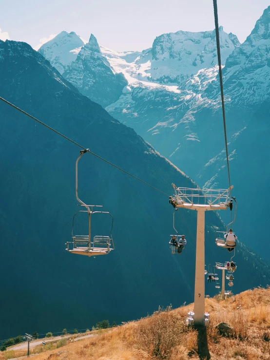 a ski lift rides on a scenic mountain side