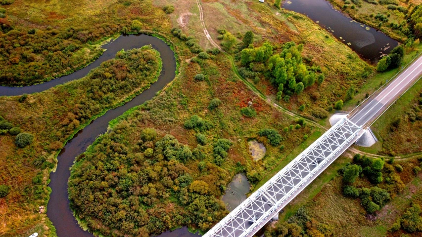 an aerial view of a bridge over a stream