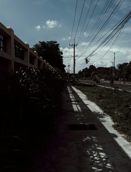 a bench sits next to electric lines under blue skies