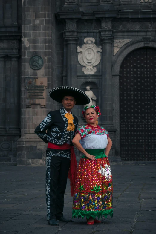 a couple in costumes stand next to each other