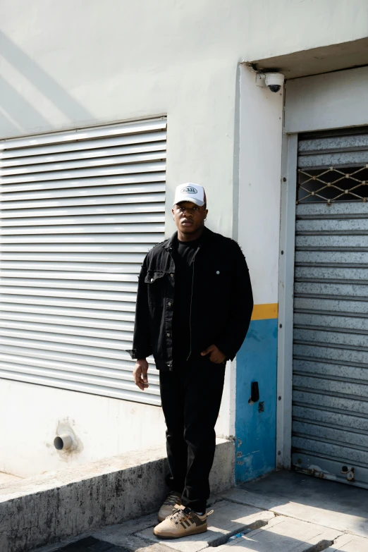 a man standing in front of a garage door