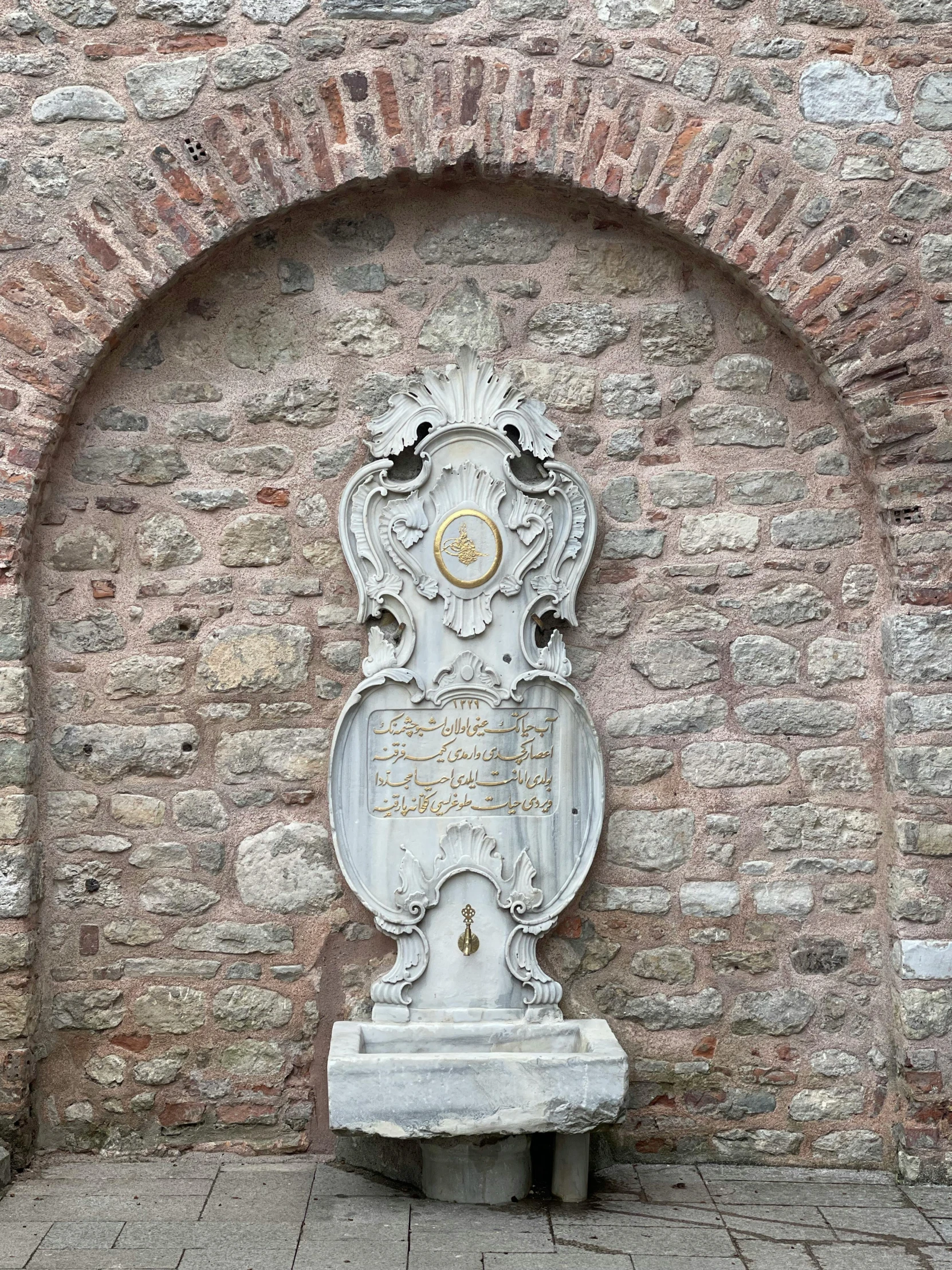 the memorial is displayed on a brick wall