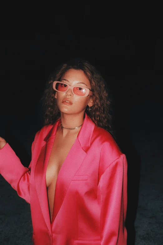a young woman in a pink jacket with gold eye glasses