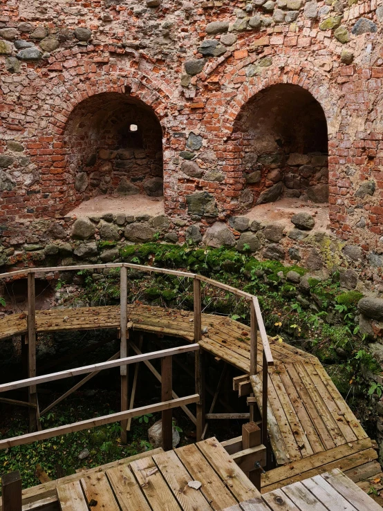 a stone wall and some wooden steps leading up