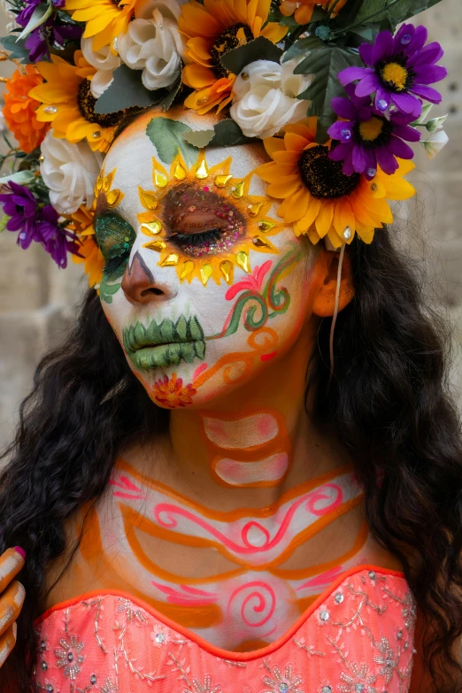 a woman is wearing makeup and flowers on her head