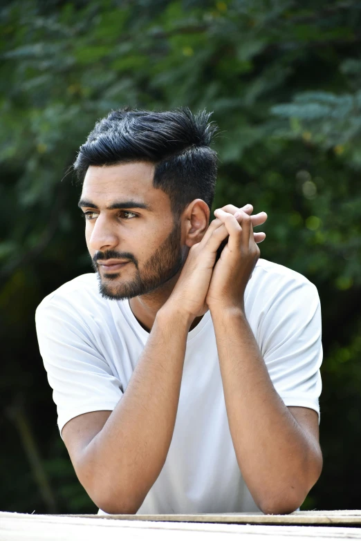 the man is posing for a picture in his white shirt