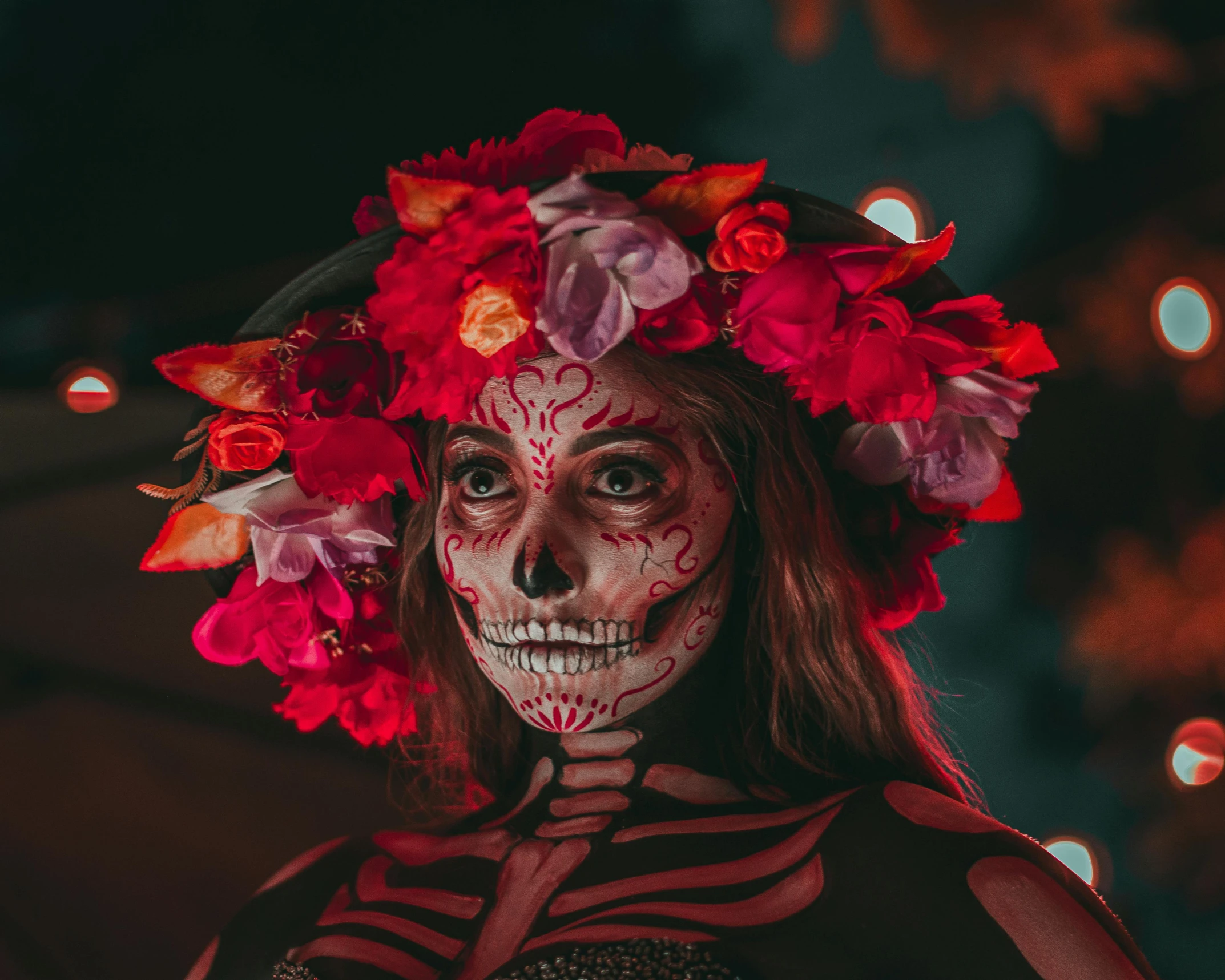 a woman wearing skeleton makeup in the dark