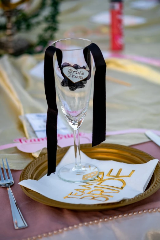 the wine glasses are on a gold plate