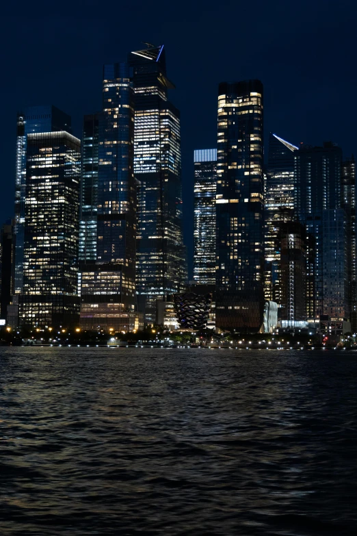 a large city lit up at night by the water