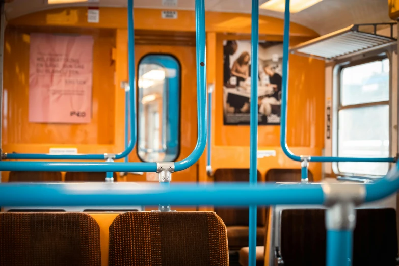 inside the subway car of a train, including some seats