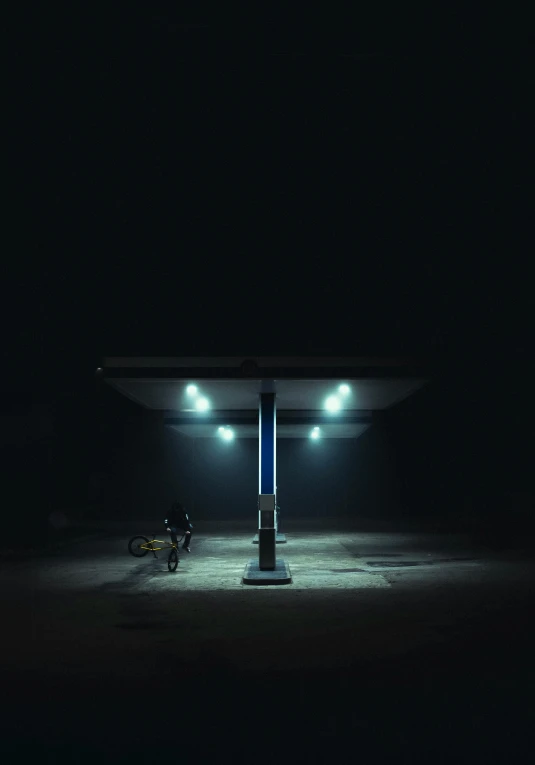 a man on his bike in a dark parking lot