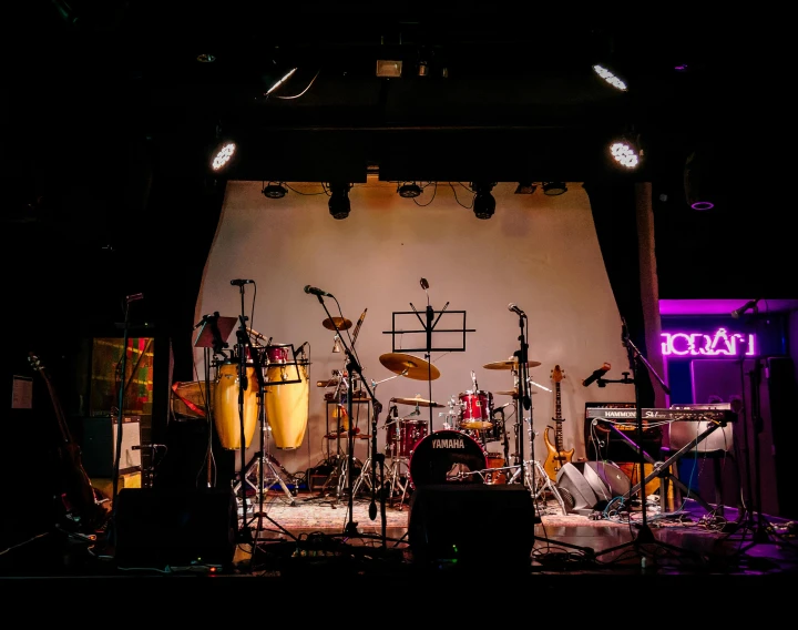 a set up concert in a white room with lots of instruments and sound equipment