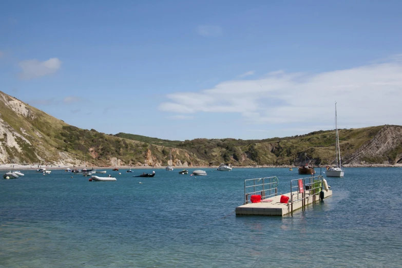 a boat on a body of water surrounded by hills