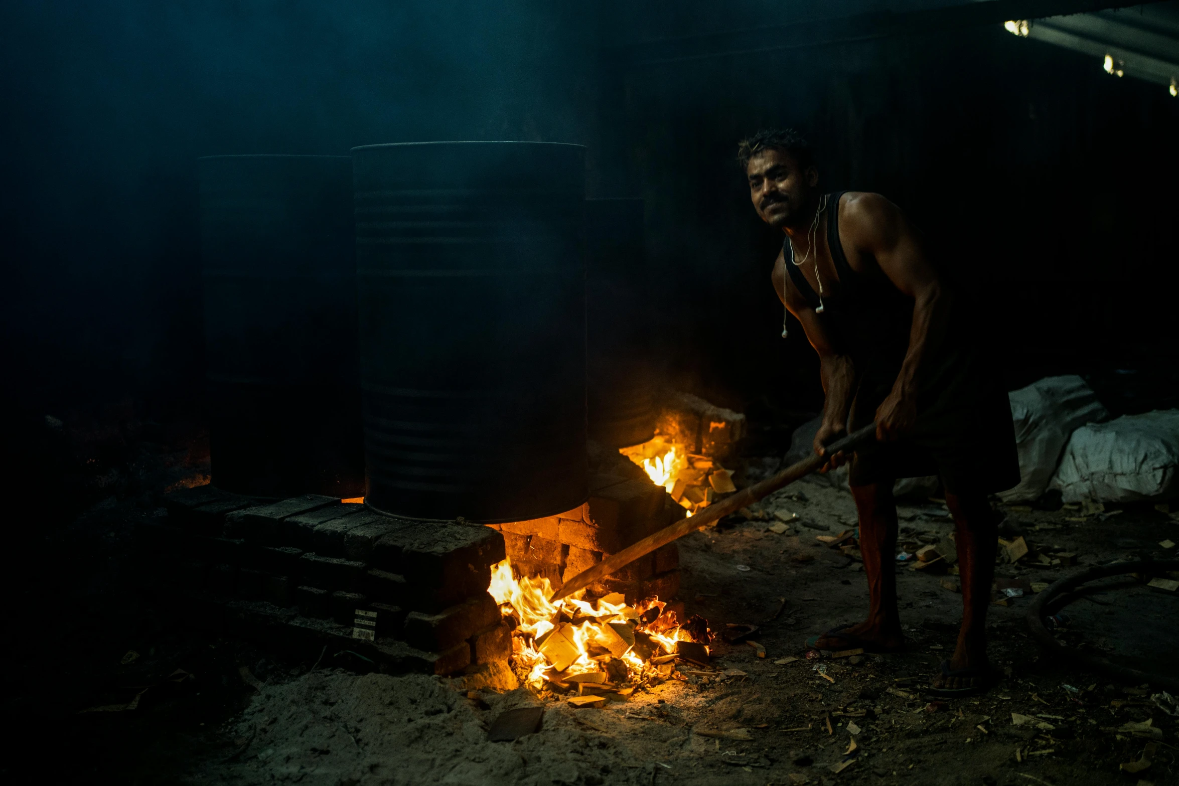 there is a man that is grilling a fire