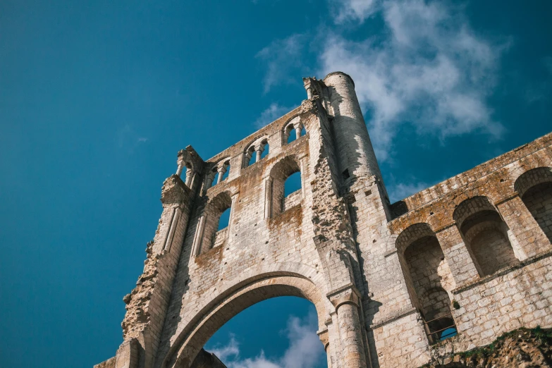 a tall brick tower with arches on the top of it