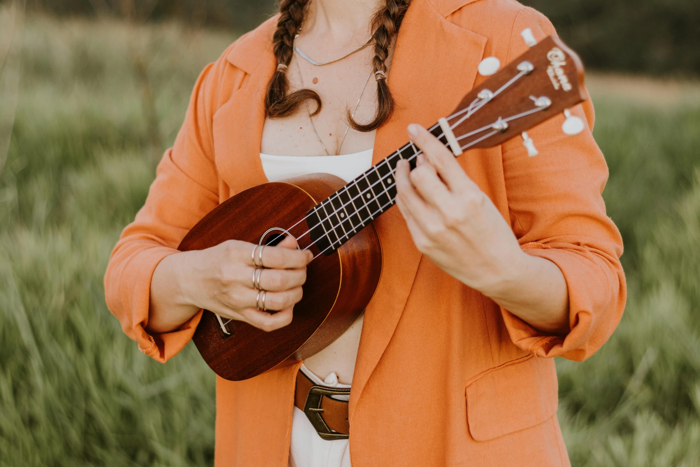 woman with id holding a ukelee in her hands