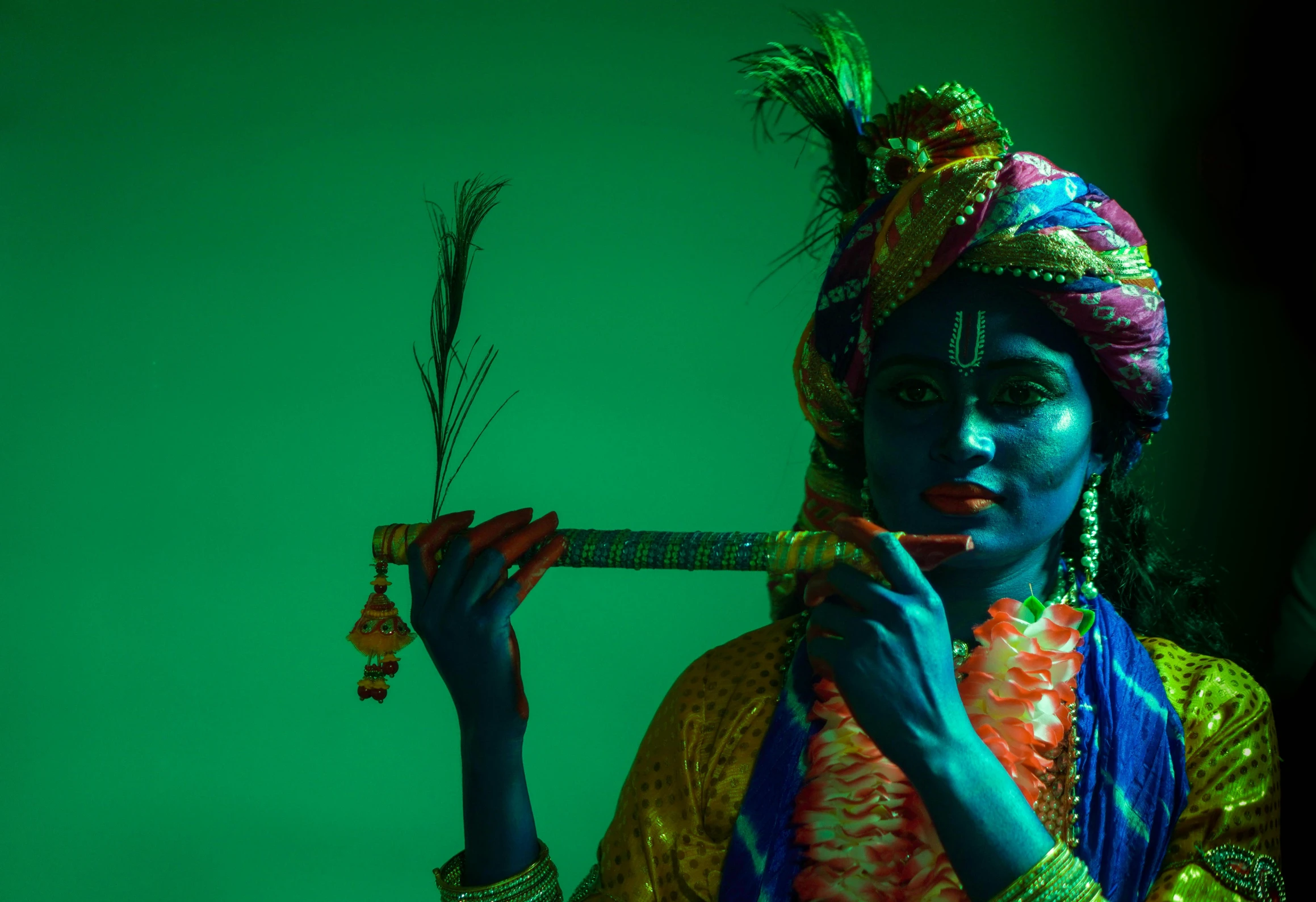 a woman holding up an arrow near green walls