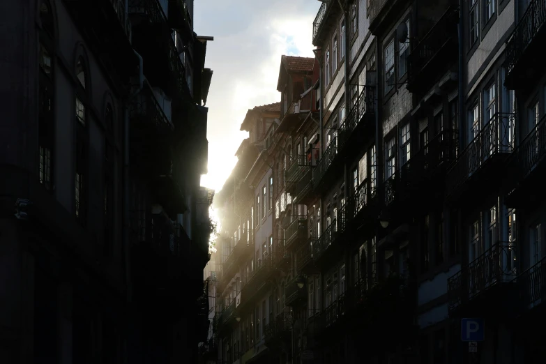 the sun peaking through windows in an apartment building