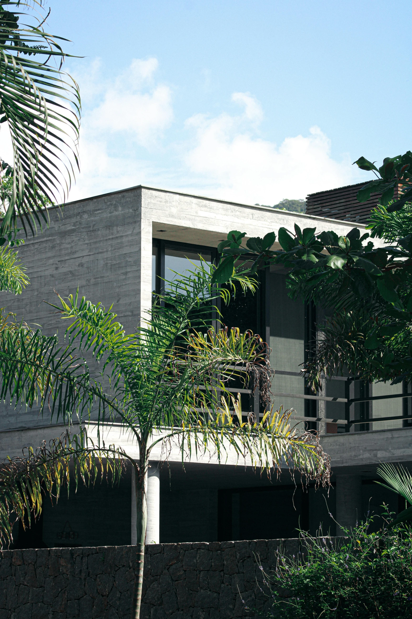 a house with trees and a fence in front