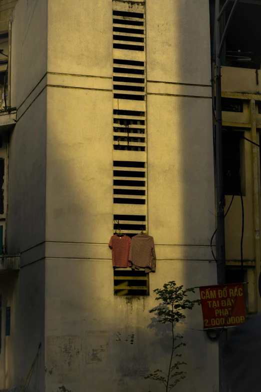 a building with a wall and window shutters in the middle