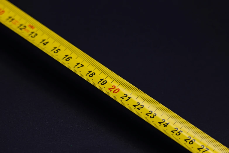 a yellow measuring tape sitting on top of a blue counter