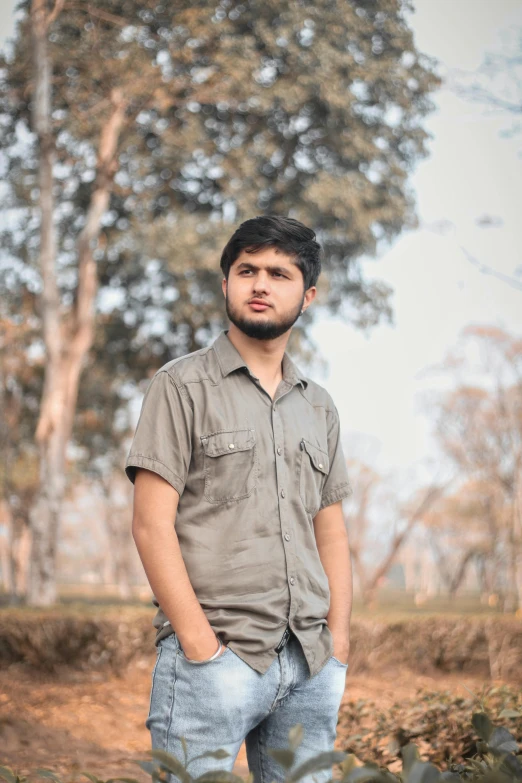 an indian man standing in the middle of an empty field