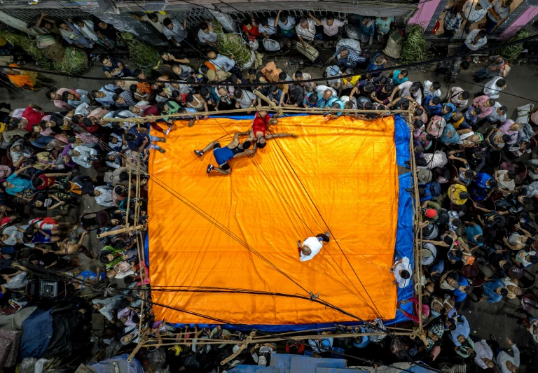 a huge crowd gathers in a big city