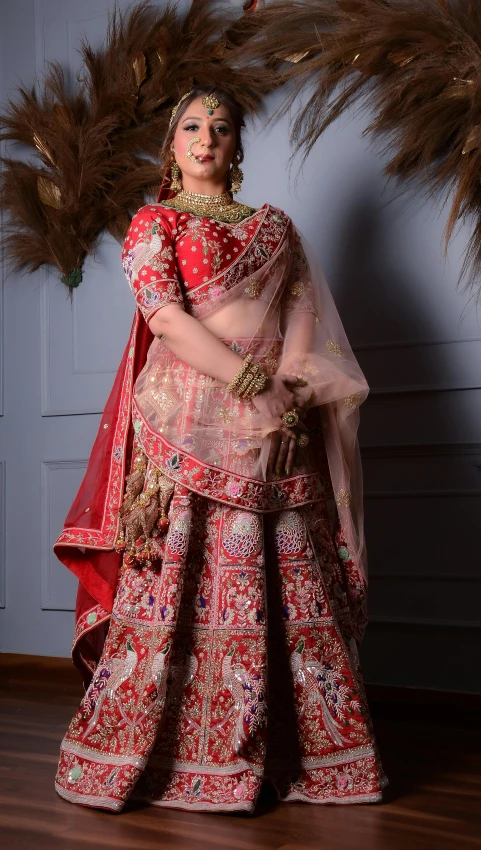 woman in red and gold outfit with feather arrangement