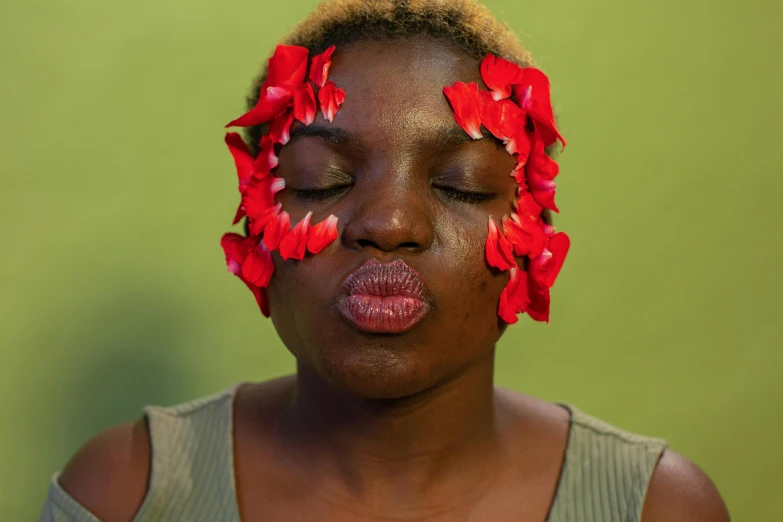 a woman that is licking her lips covered by flowers