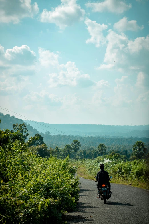 person riding a motorcycle on a scenic road