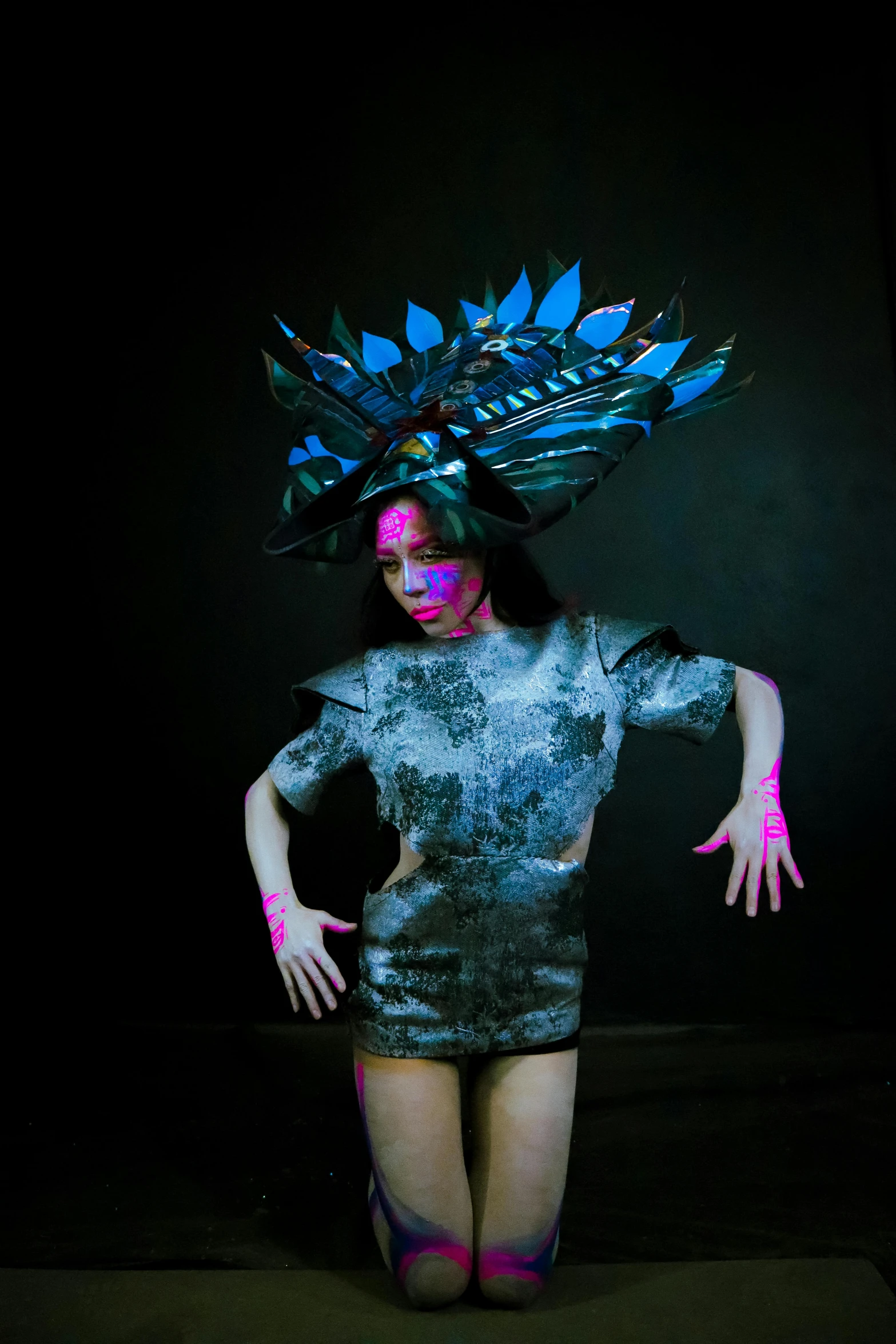 woman with a colorful hair and make - up in black background