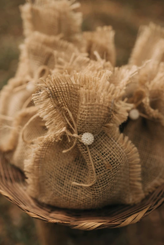 small bags of burlap cloth with a tiny ring and a string bow