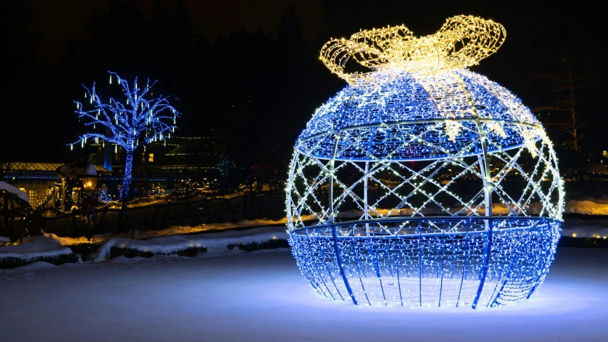 a decorative object lit up at night in the snow