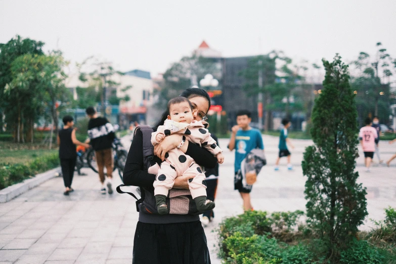 there is a woman walking with two children