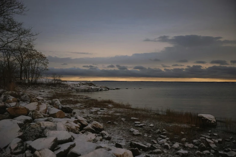 some very pretty snow covered shore line next to a lake